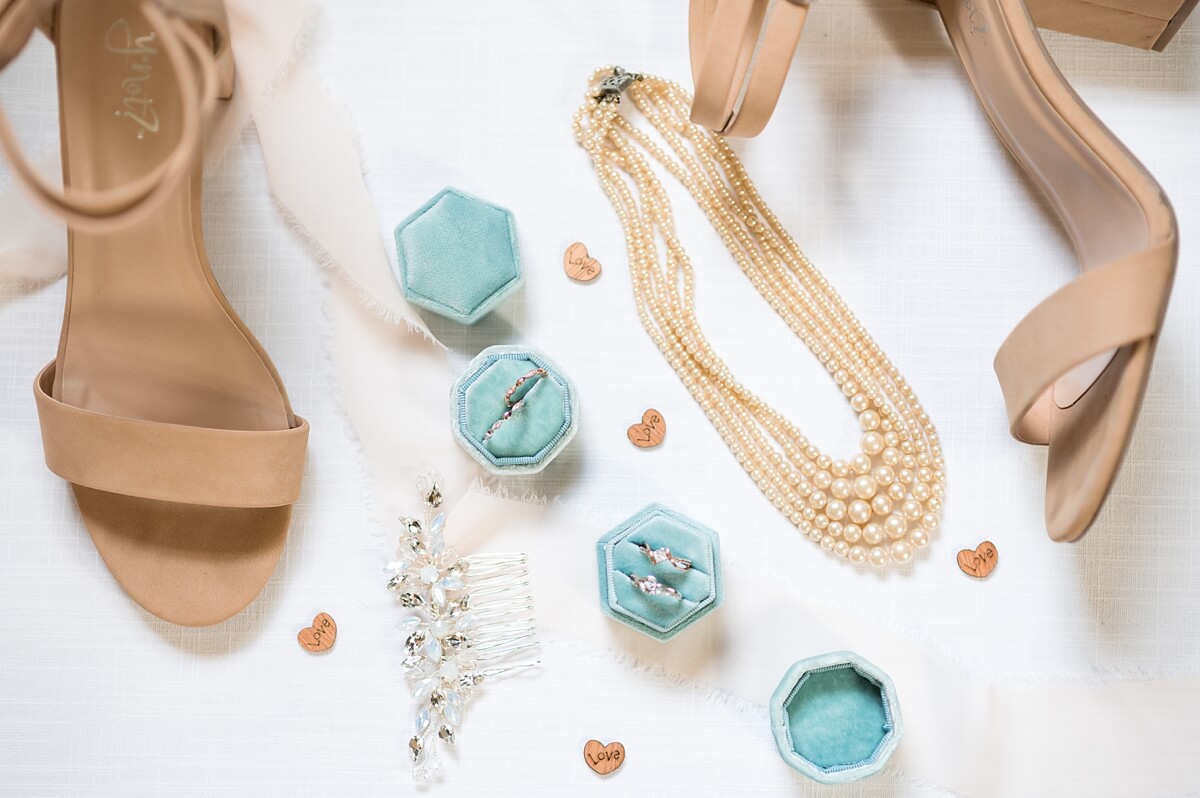 Bride's tan shoes with necklace and wedding rings in turquoise boxes