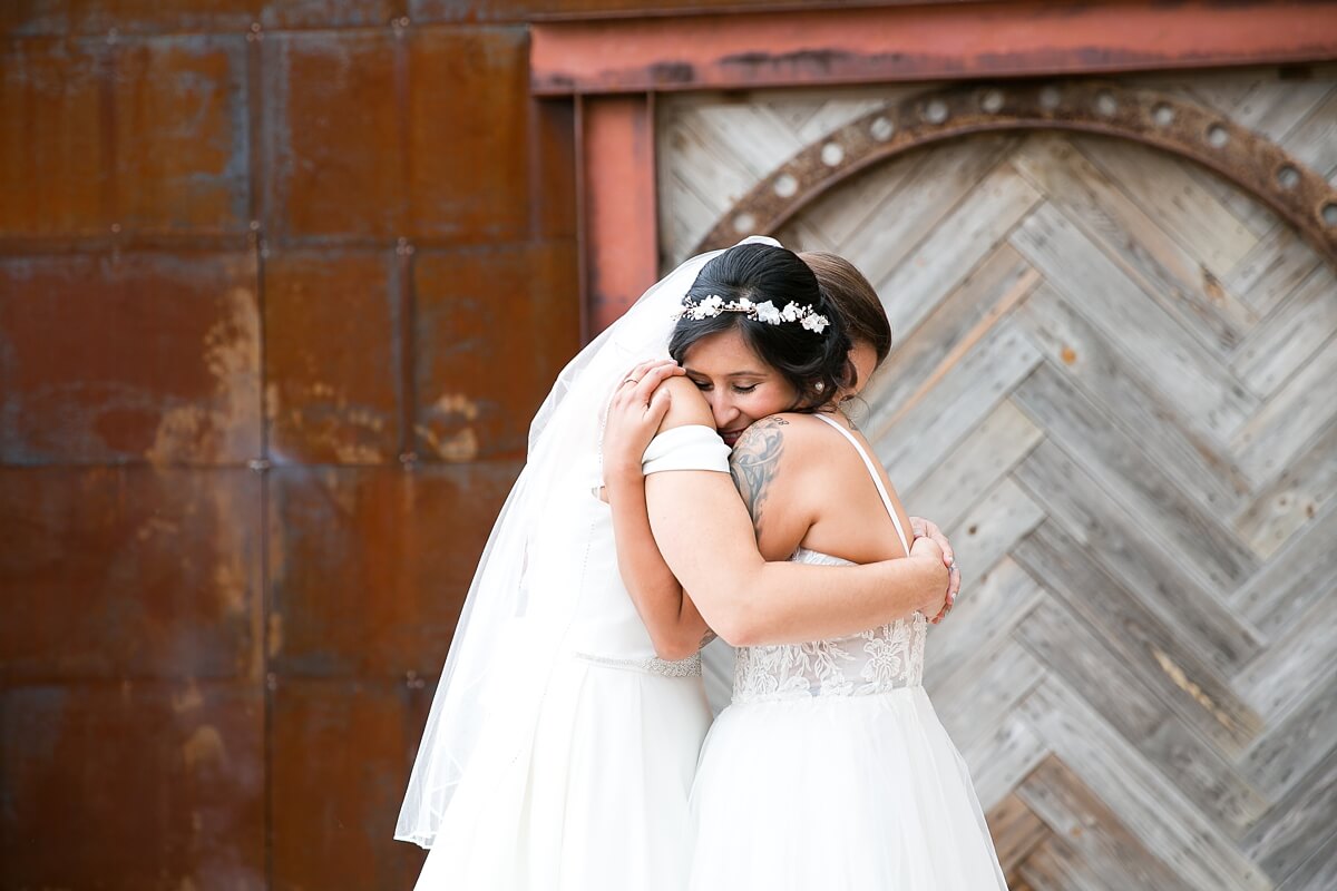Brides hugging during first look at The Haight