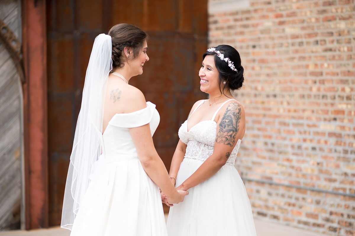 Brides holding hand during first look at The Haight