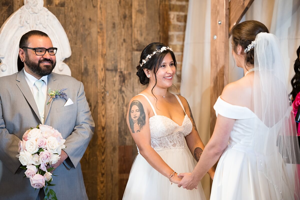Brides looking at each other during the ceremony