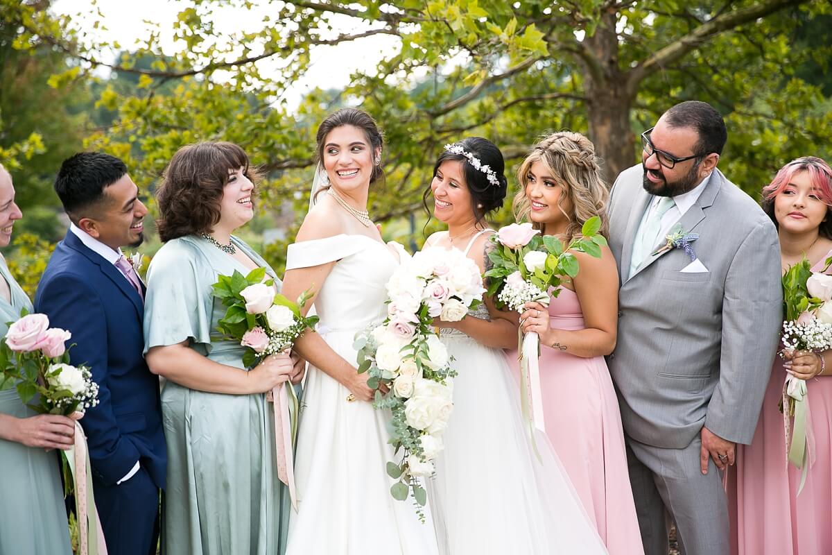 Brides looking at wedding party during photos