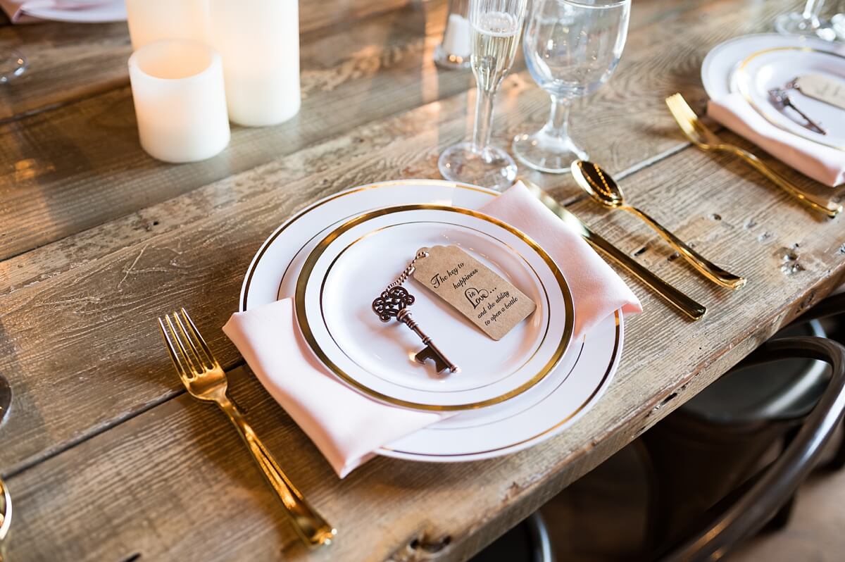 White place setting with pink linen and gold place setting at The Haight