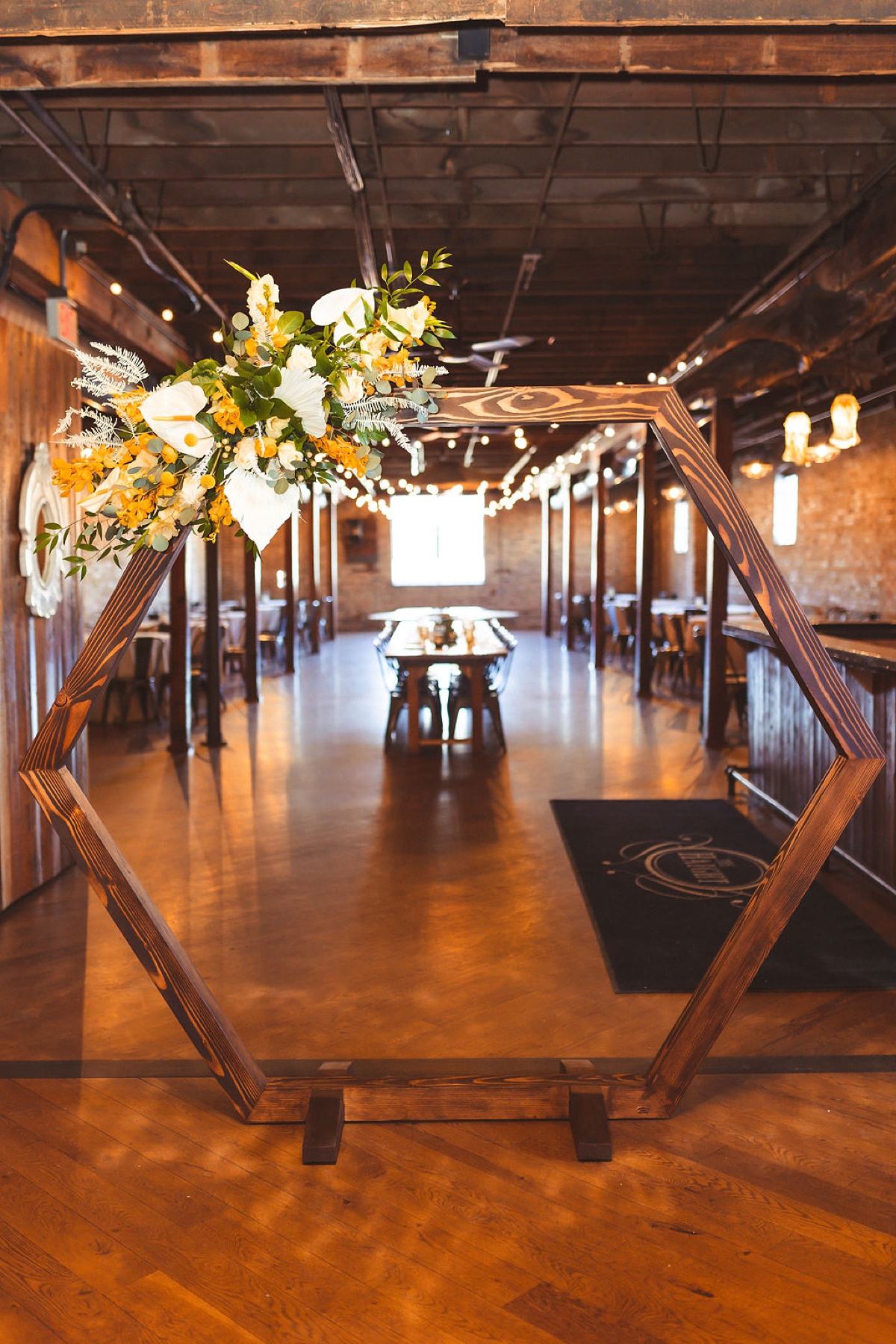 Hexagon arch with yellow and white flowers at loft wedding venue Chicago