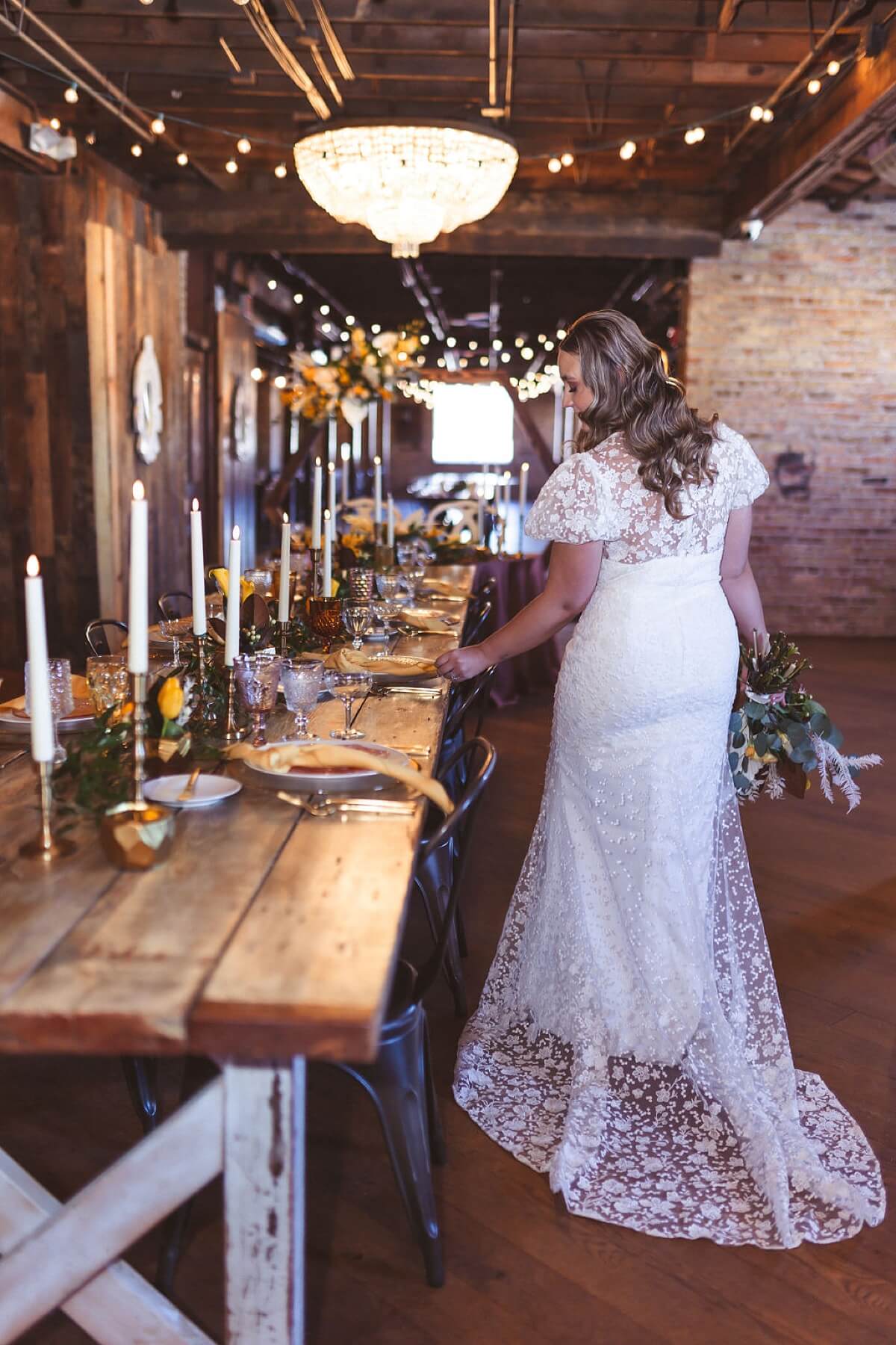 Bride looking at place settings at styled shoot