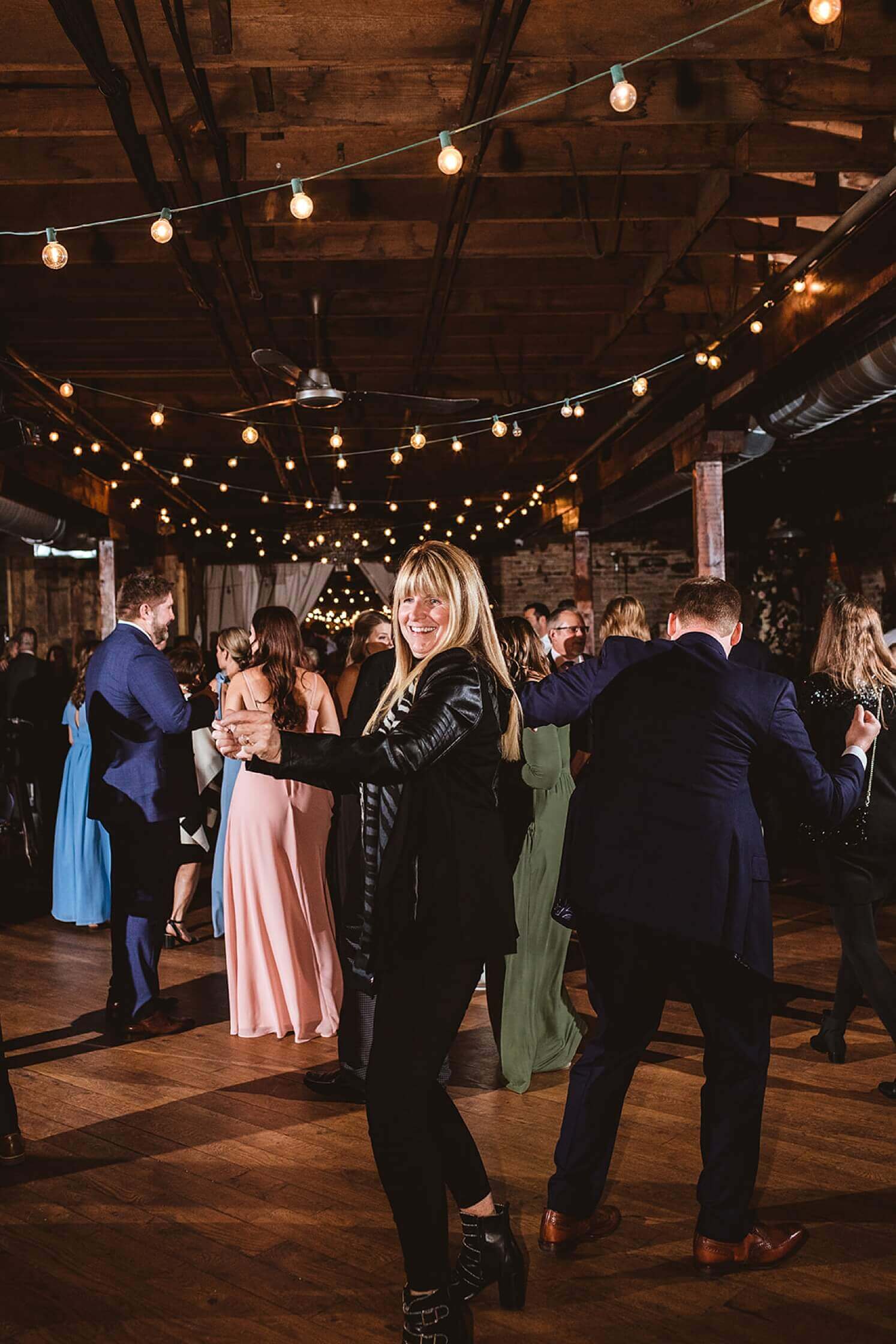Wedding guests dancing at reception at The Haight, a winter wedding venue