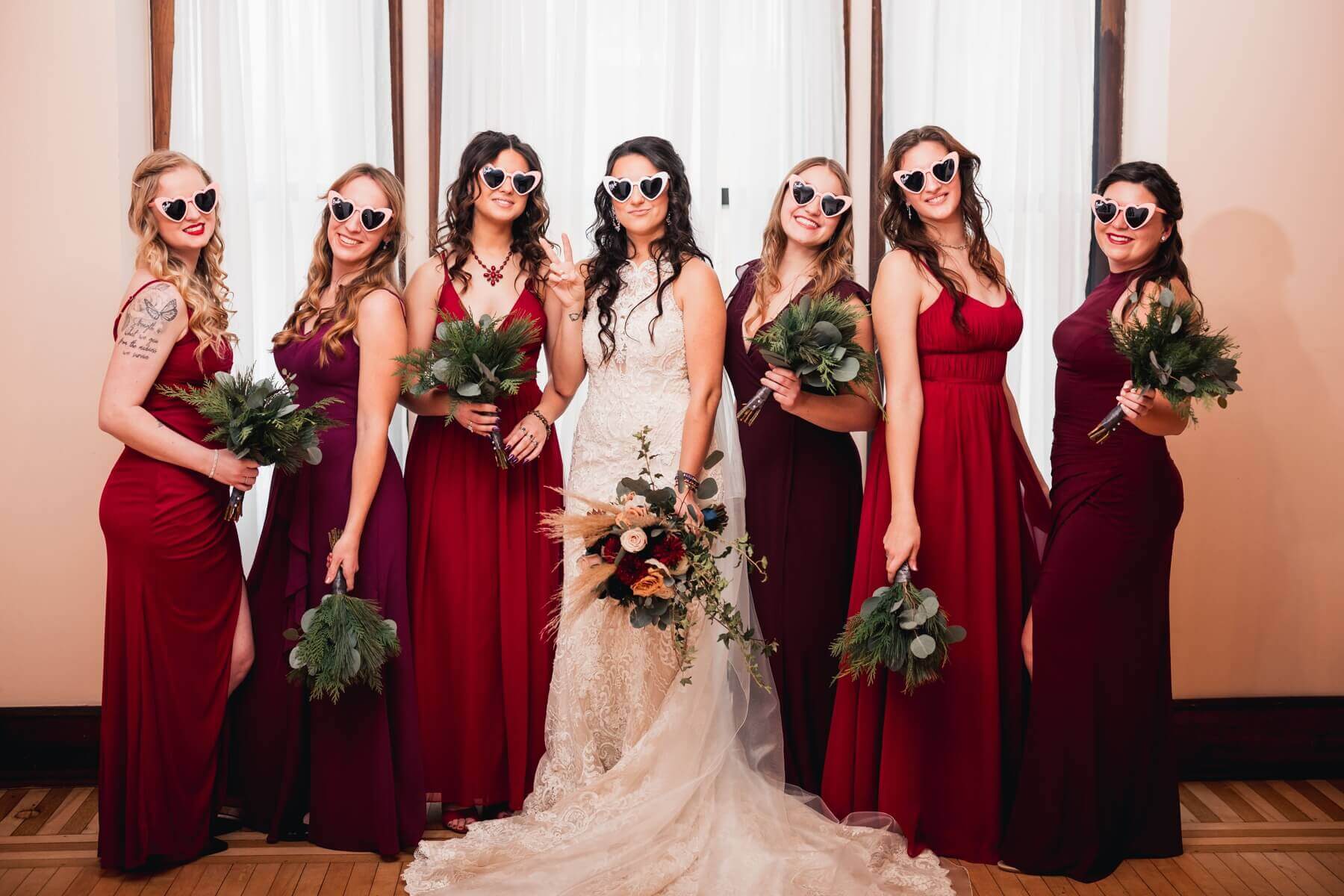 Bride and bridesmaids wearing heart sunglasses at wedding venue in Illinois