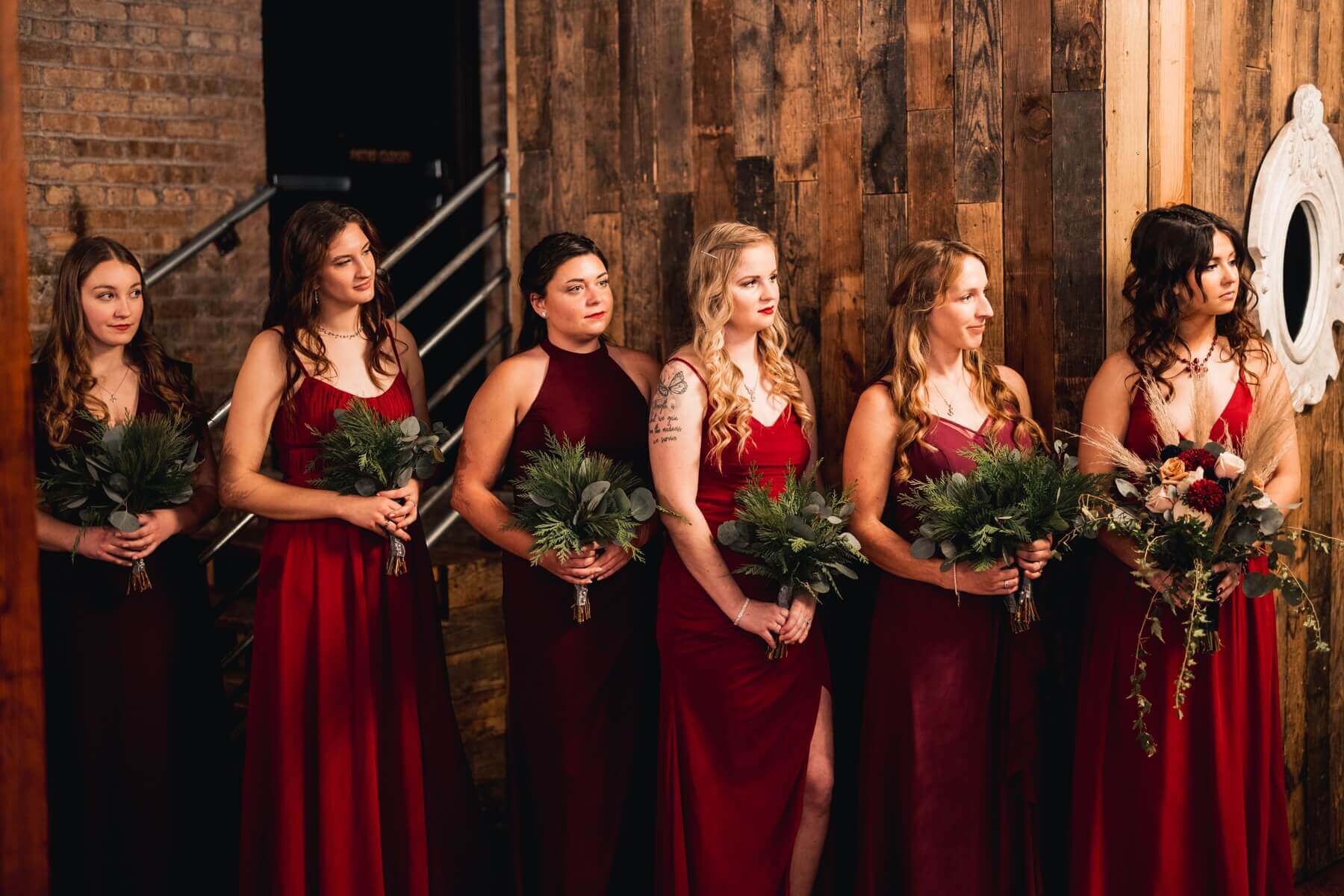 Bridesmaids wearing dresses in shades of crimson