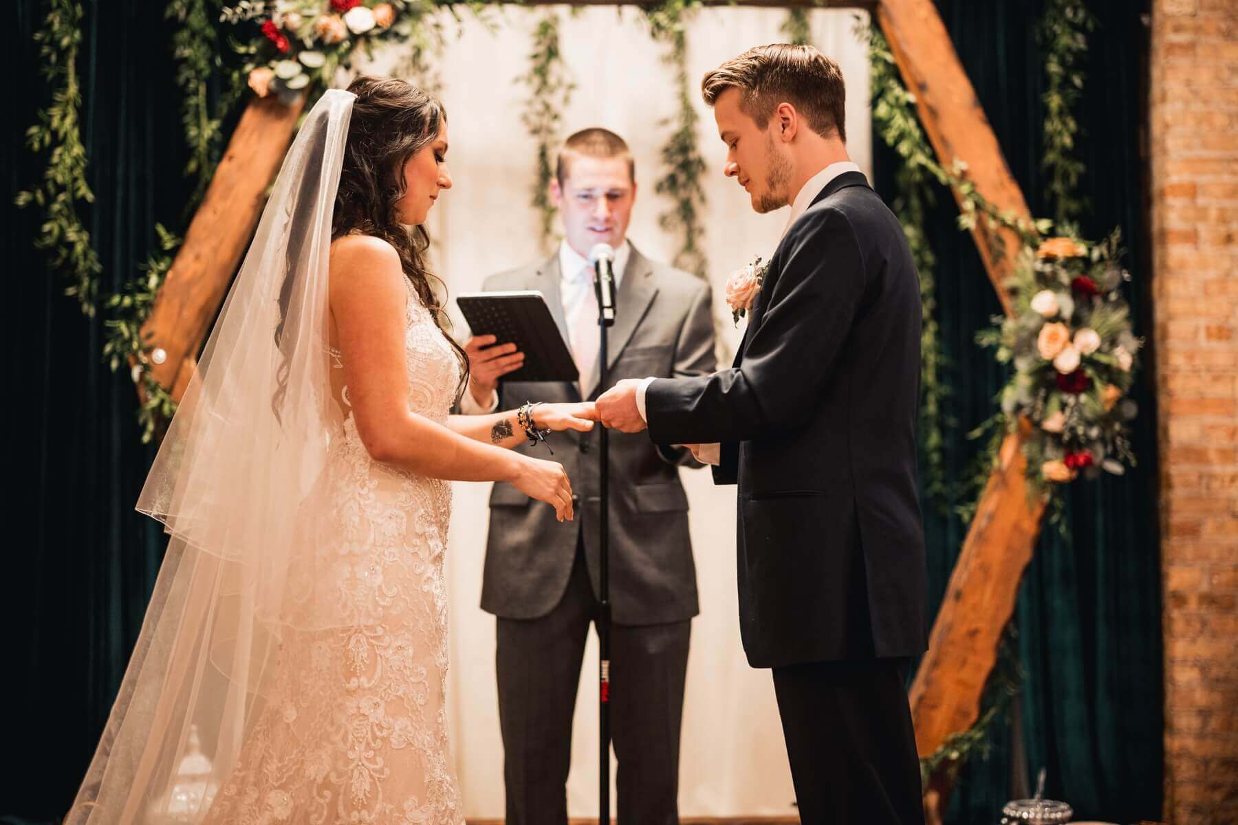 Bride and groom exchanging rings at wedding venue in Illinois
