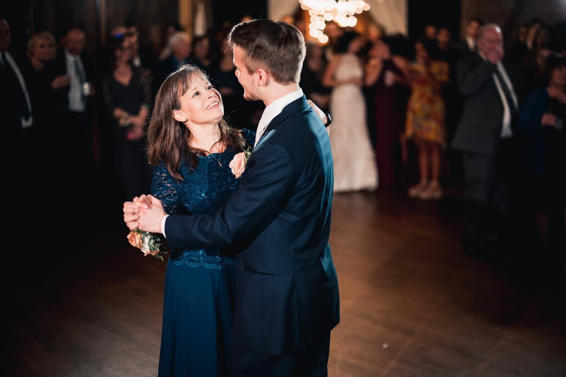 Groom dancing with mom at wedding venue in Illinois