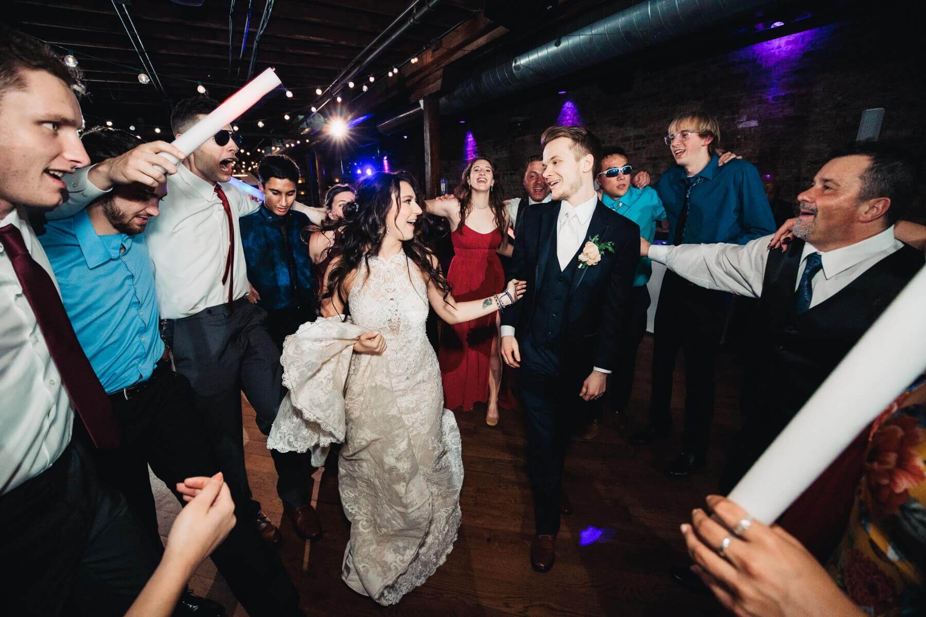 Bride and groom dancing with wedding guests at wedding venue in Illinois