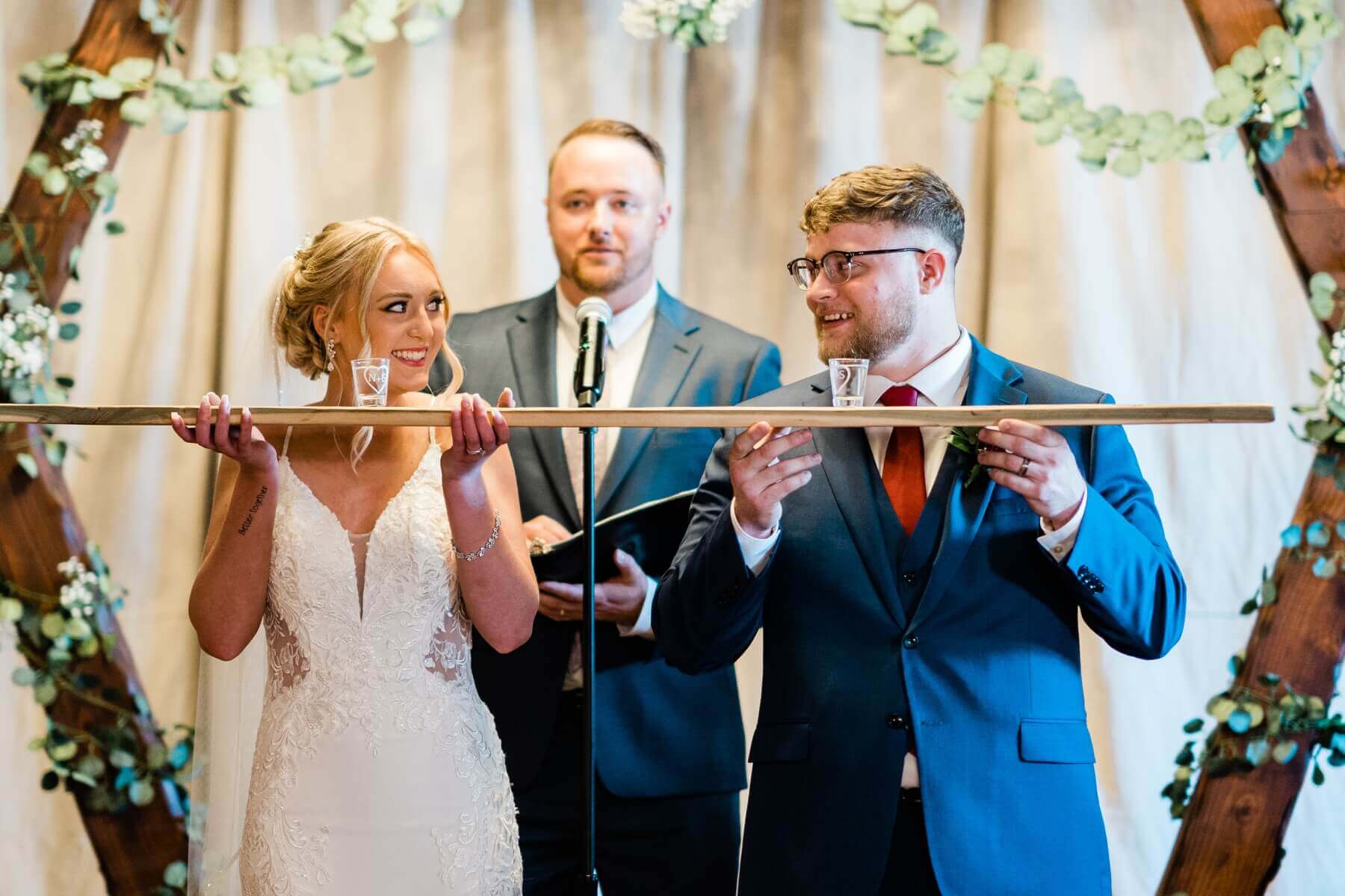 Bride and groom looking at each other before doing a shotski