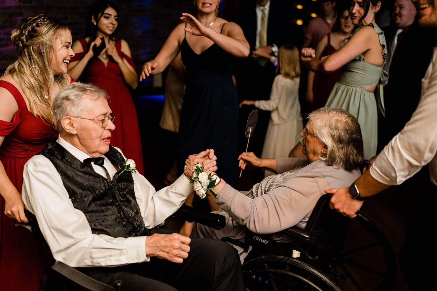 Grandma and grandpa dancing in wheelchairs during wedding reception at The Haight