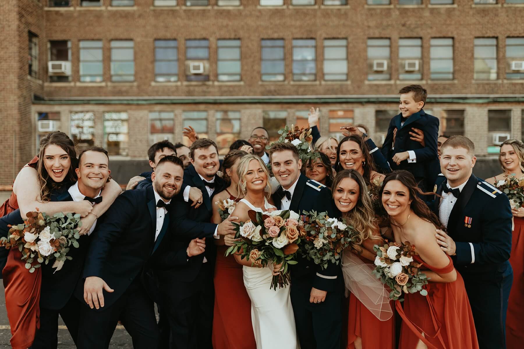 Bride and groom in candid shot with wedding party