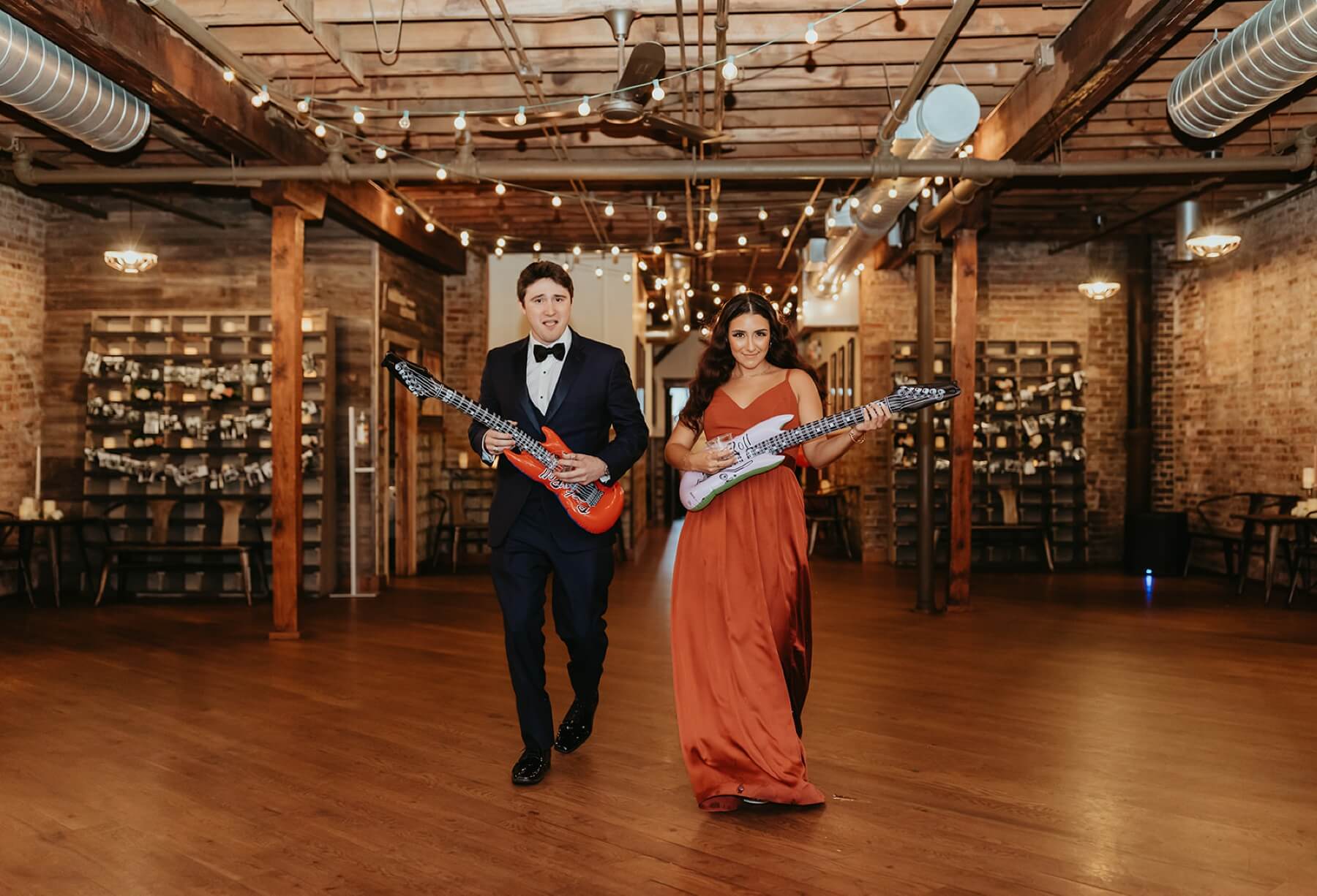 Bridesmaid and groomsman walking in with electric guitars