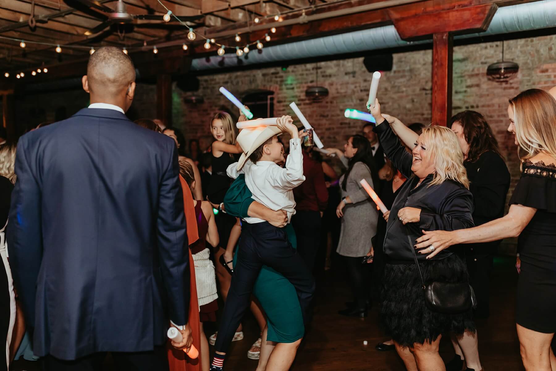 Wedding guests dancing with foam glow sticks