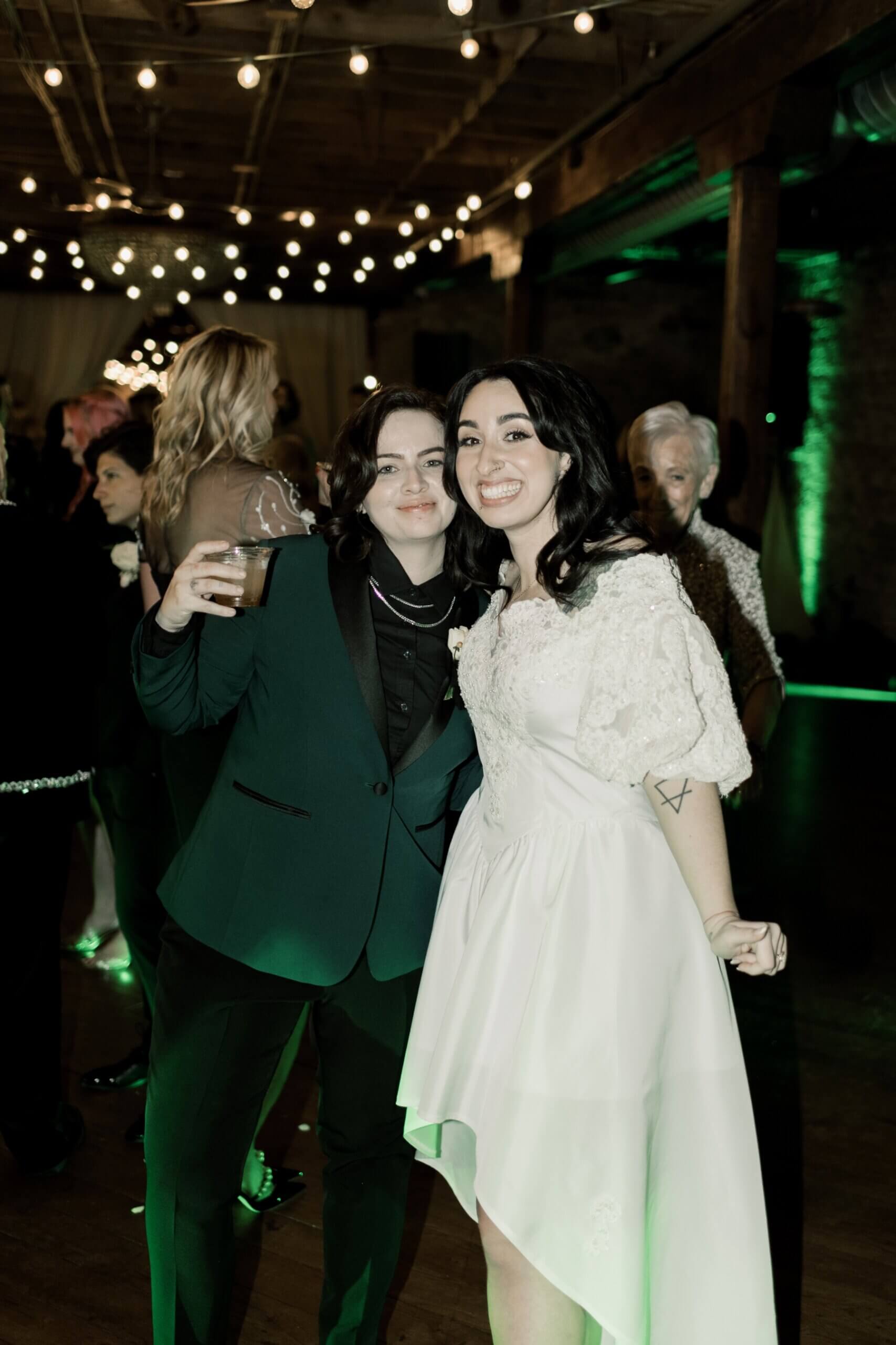 Couple enjoying green and black wedding reception at The Haight