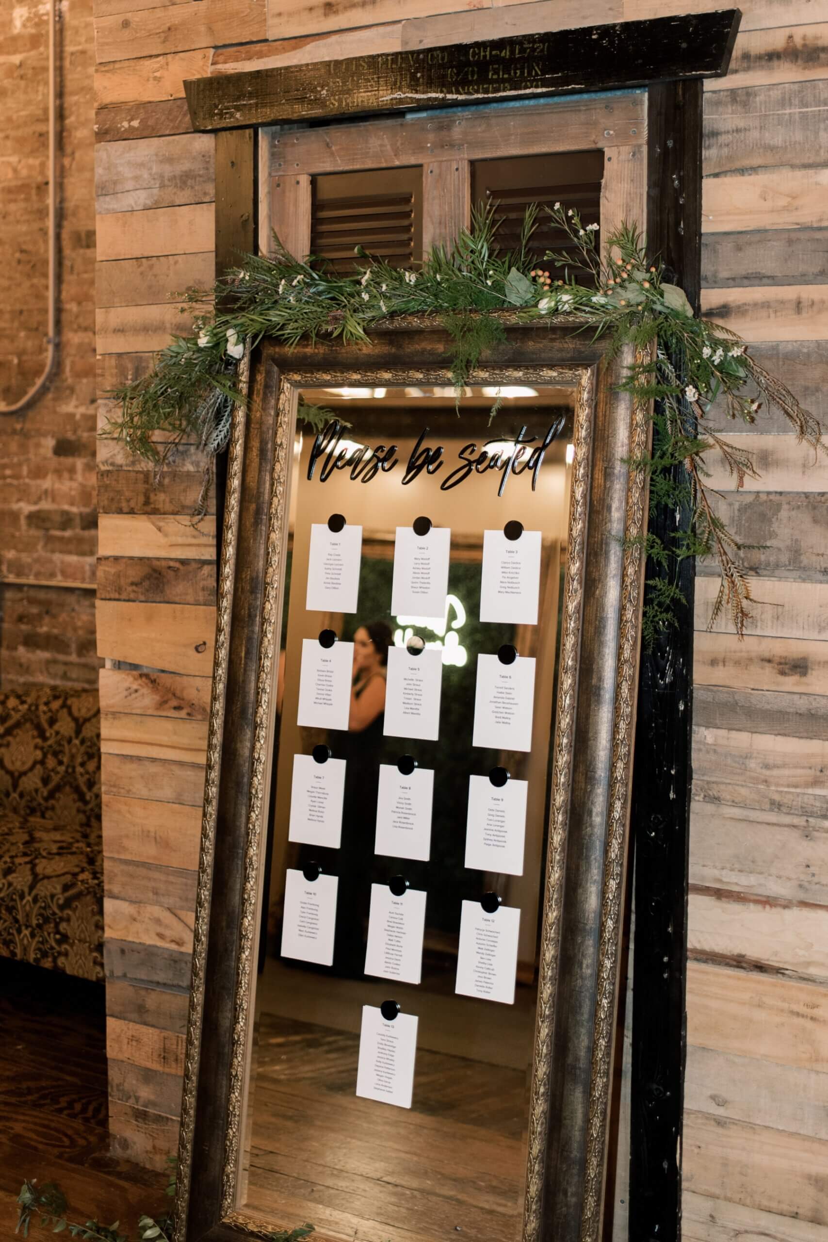 Mirror seating chart featuring green and black reception details