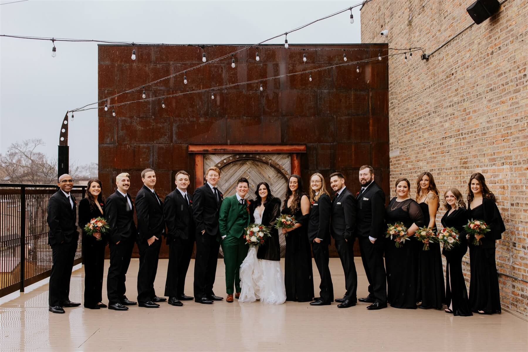 Couple with wedding party who is all wearing black