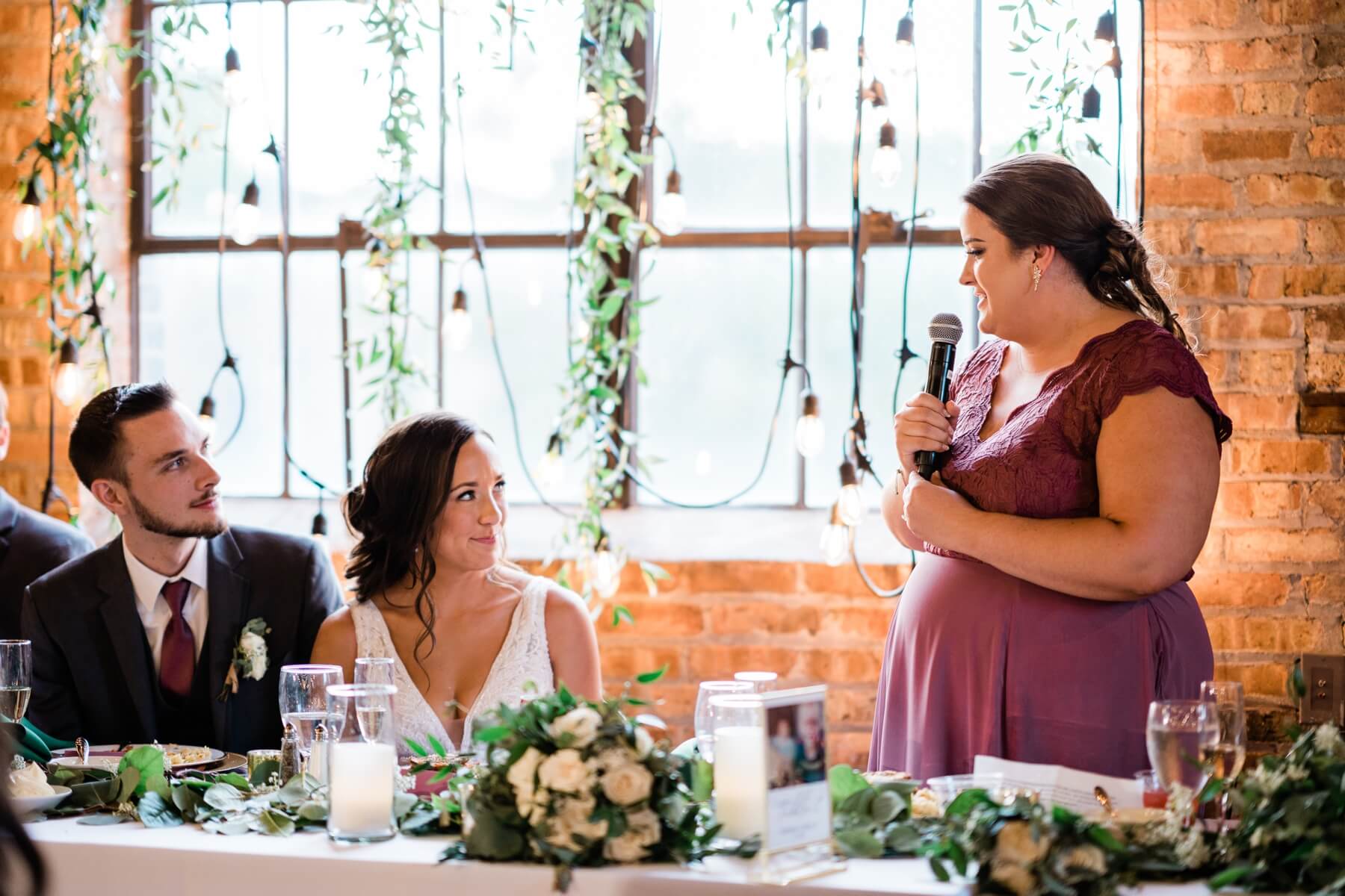 Maid of honor giving speech at wedding reception