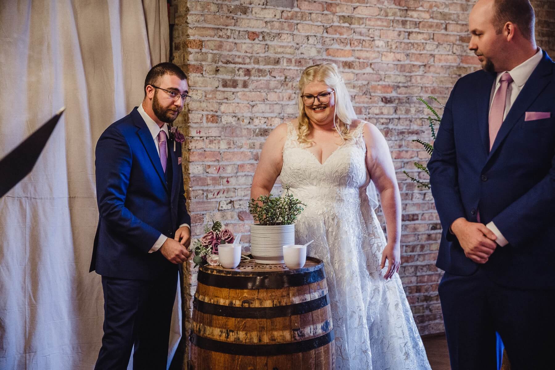 Bride and groom participating in succulent unity ceremony