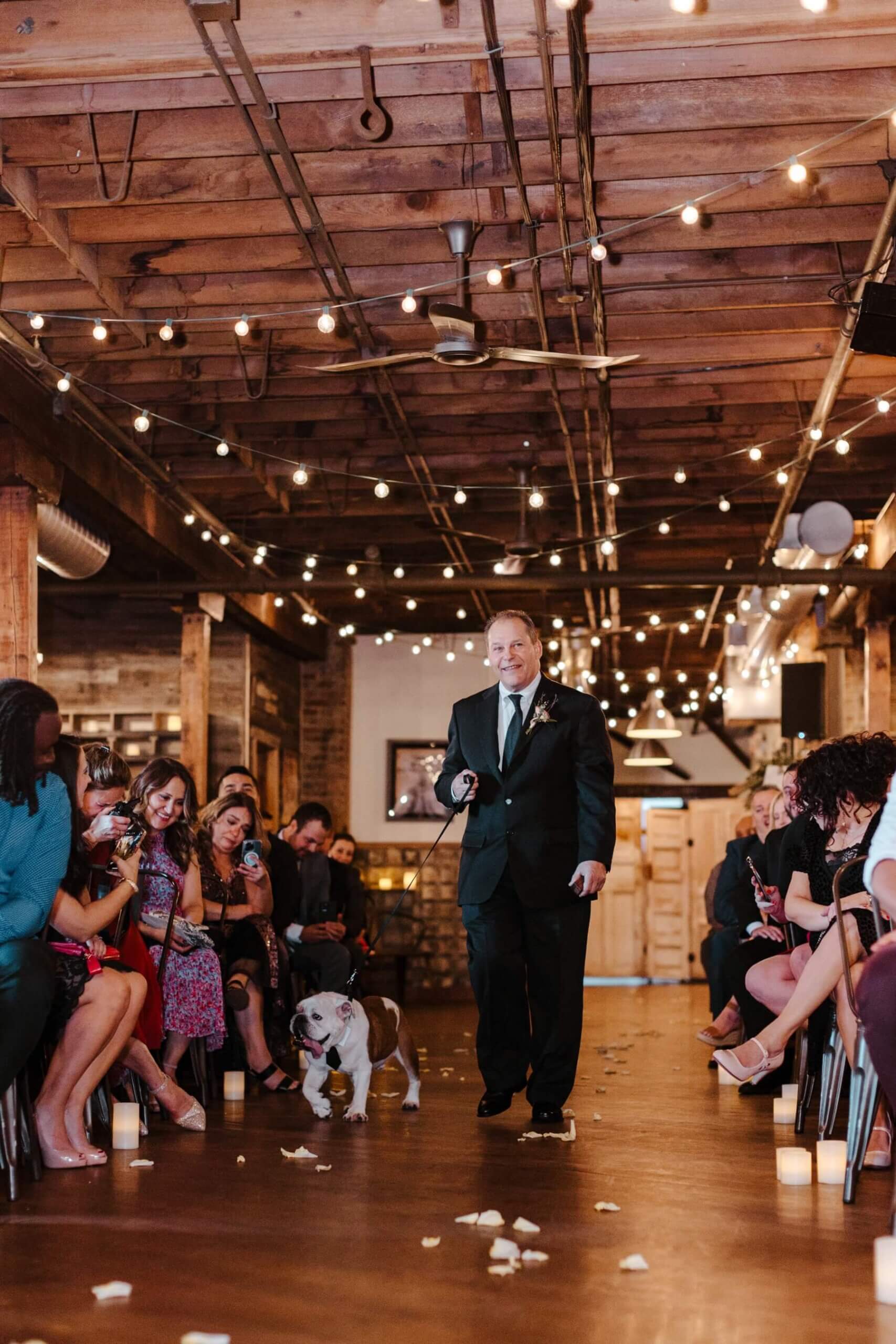 Bride and groom's bulldog walking down the aisle during ceremony