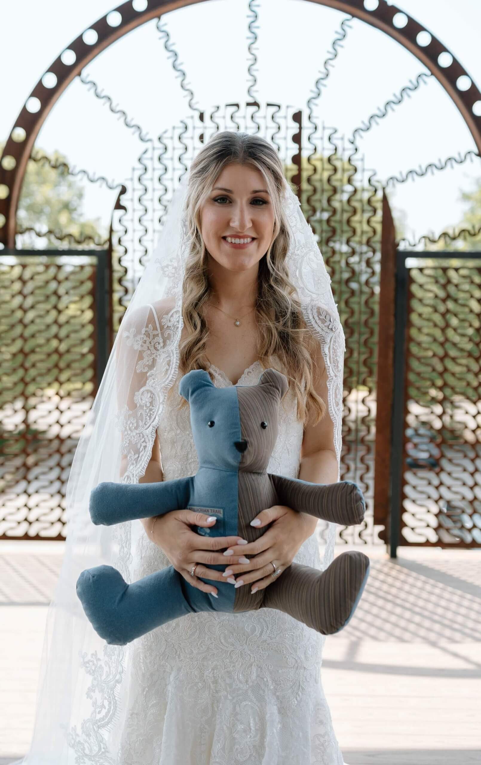 Bride holding bear made from dad's clothes